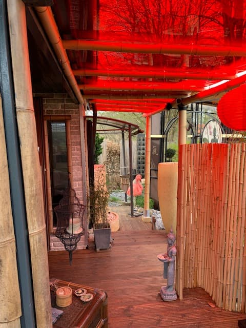 Door canopy made of red tinted plexiglass and bamboo