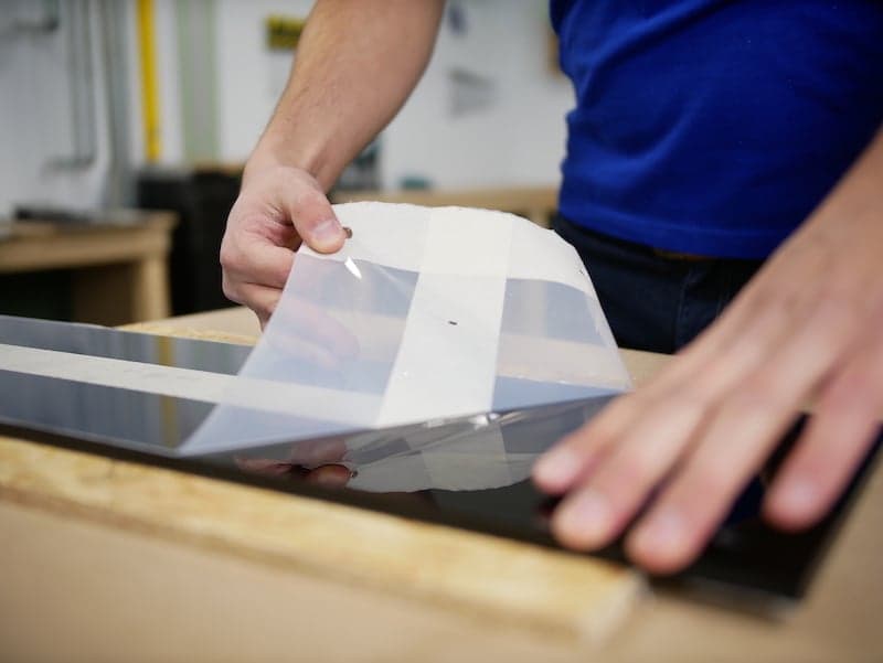 Removing protection foil from acrylic sheet