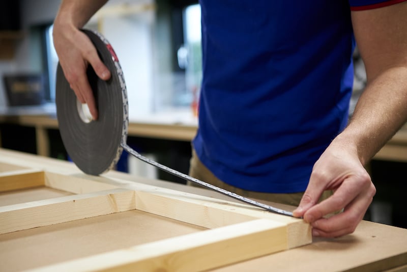 Sticking the foam tape to the ceiling frame