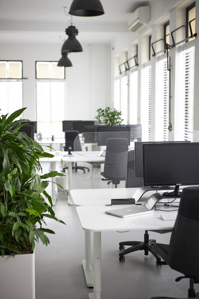 Large perspex screen between two desks