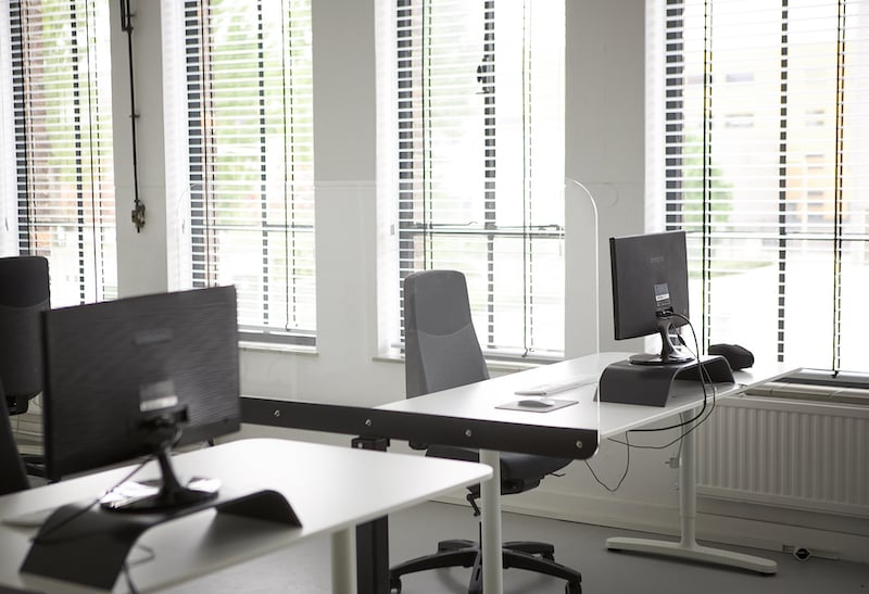 Perspex screen on a base between desks